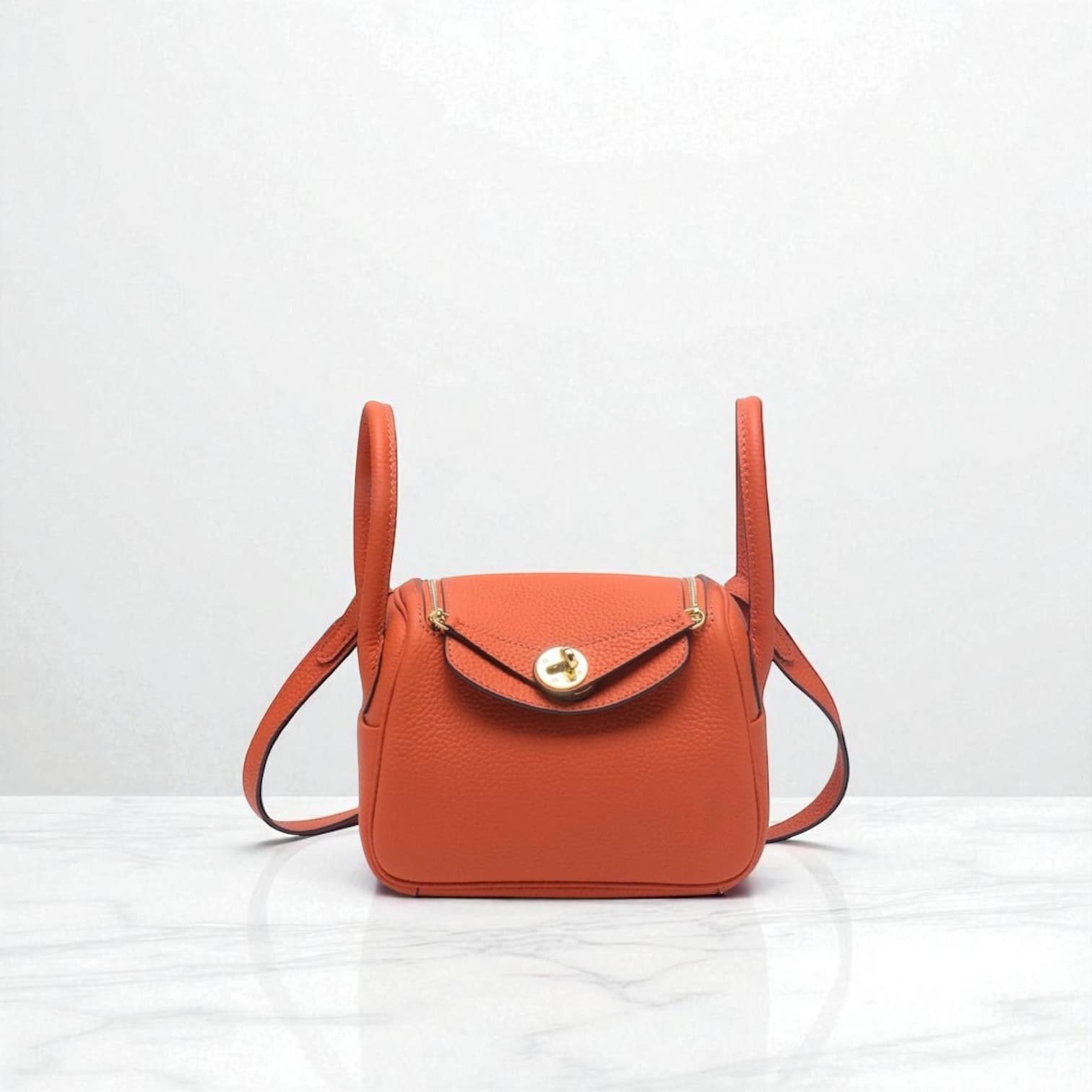 212 牛革RDバッグ/Sサイズ オレンジ / 高級感を演出するゴールド金具